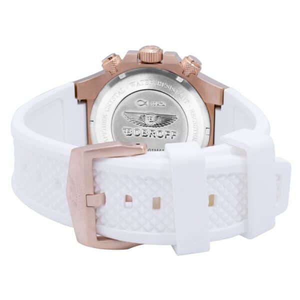 Montre avec bracelet blanc et fond argenté.