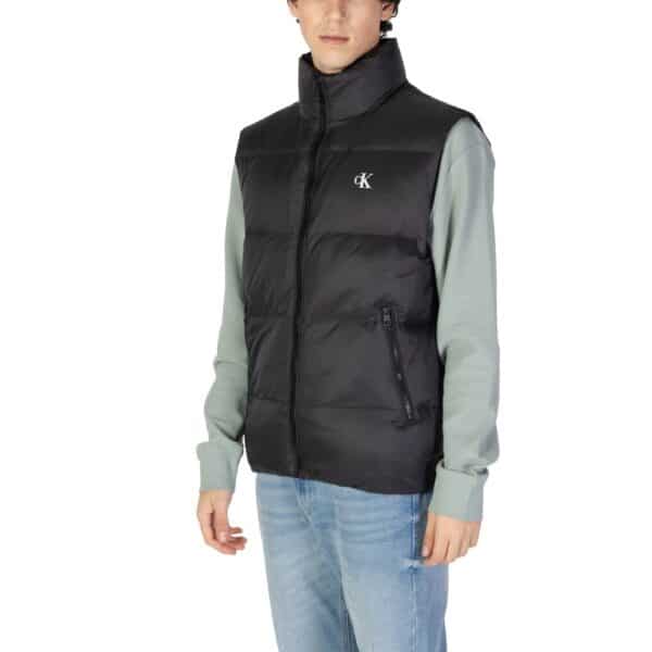 Homme portant un gilet noir sans manches.